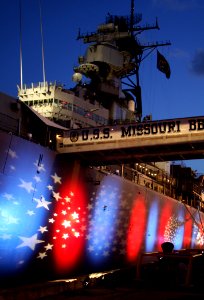 US Navy 080718-N-0879R-012 Red, white and blue lights illuminate the port side of the battleship Missouri Memorial for the Navy Great White Fleet Centennial celebration