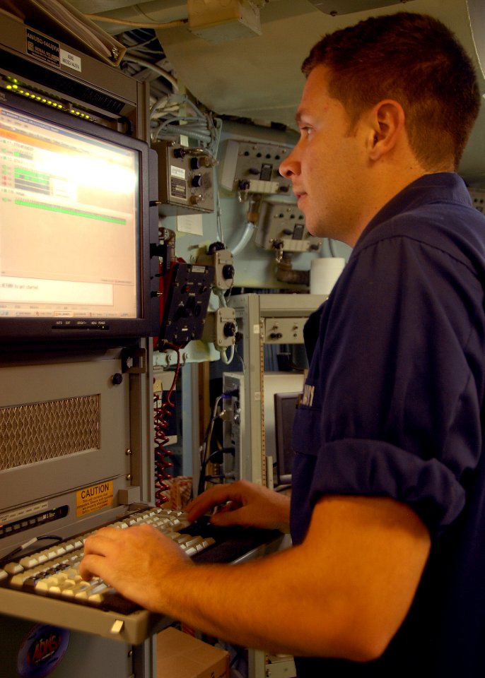 US Navy 080720-N-6999H-034 Information Systems Technician 2nd Class David Coulter troubleshoots a satellite connection for Internet services aboard the amphibious assault ship USS Bonhomme Richard (LHD 6)