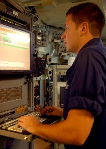 US Navy 080720-N-6999H-034 Information Systems Technician 2nd Class David Coulter troubleshoots a satellite connection for Internet services aboard the amphibious assault ship USS Bonhomme Richard (LHD 6)
