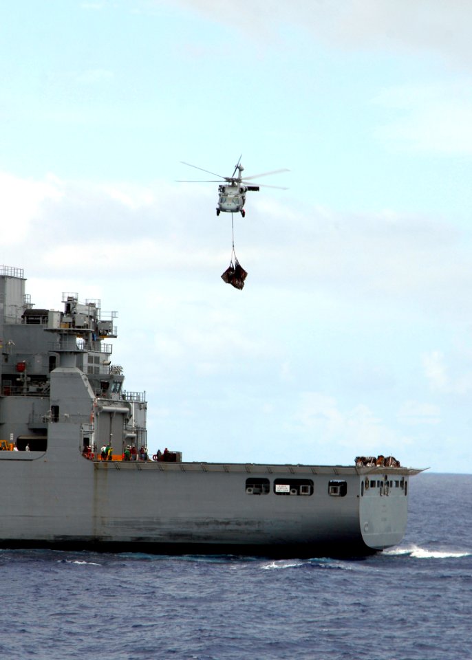 US Navy 080718-N-4236E-406 An MH-60S Seahawk assigned to Helicopter Sea Combat Squadron (HSC) 28 picks up mail, supplies, and food from the Military Sealift Command dry cargo-ammunition ship USNS Sacagawea (T-AKE 2)