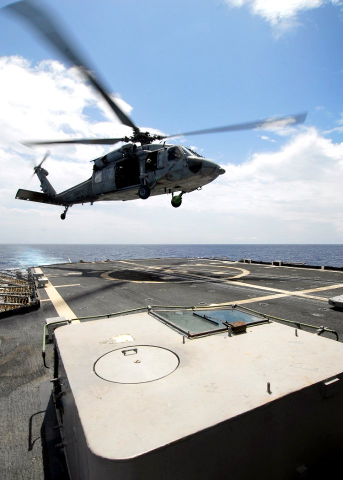 US Navy 080718-N-4236E-223 An MH-60S assigned to Helicopter Sea Combat Squadron (HSC) 28 brings mail, supplies, and food aboard the guided-missile cruiser USS Vella Gulf (CG 72)