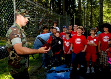 US Navy 080715-N-4649C-001 Master-At-Arms 3rd Class Ian Stephenson shows a group of children from the youth group Starbase Atlantis tools used to train military working dogs