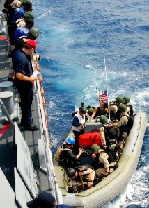 US Navy 080721-N-4236E-002 The visit, board, search, and seizure team from the guided-missile cruiser USS Vella Gulf (CG 72) boards a rigid hull inflatable boat in order to conduct a boarding exercise