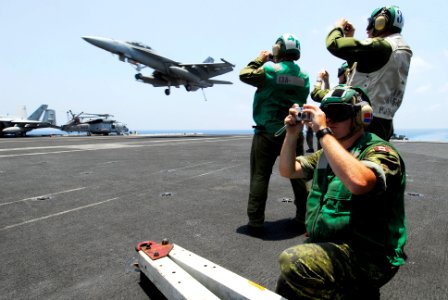 US Navy 080715-N-7883G-035 Canadian service members assigned to the 409 Tactical Fighter Squadron watch as an F-A-18F Super Hornet assigned to Strike Fighter Squadron (VFA)102 lands aboard the aircraft carrier USS Kitty Hawk (C