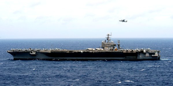 US Navy 080721-N-7241L-003 A French E-2C Hawkeye assigned to the 4th Squadron flies over the aircraft carrier USS Theodore Roosevelt (CVN 71) during combined French and American carrier qualifications