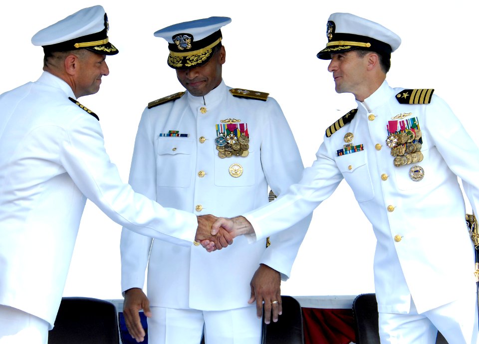 US Navy 080718-N-8467N-006 Capt. Kenneth M. Perry, right, and Captain Robert P. Burke shake hands after Perry reports to Rear Adm. Bruce E. Grooms, commander, Submarine Group Two, center, that he has been relieved by Burke as c