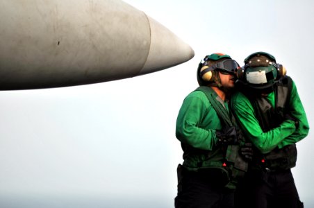 US Navy 080718-N-7981E-553 Sailors communicate with each other while waiting to launch an F-A-18F Super Hornet aboard the Nimitz-class aircraft carrier USS Abraham Lincoln (CVN 72)