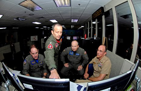 US Navy 080722-F-9750V-103 Capt. Paul Innis, Cmdr. David Little, Capt. Chris Sprinkle and Cmdr. Doug Anderson discuss a battle strategy in the 613th Air and Space Operations Center at Hickam Air Force Base, Hawaii