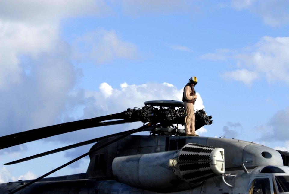 US Navy 080716-N-9500T-062 Cpl. Beaukin Prine checks the main rotor of a CH-53 Sea Stallion helicopter