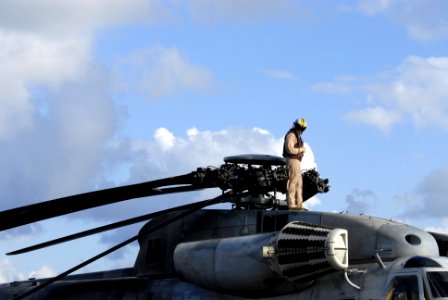 US Navy 080716-N-9500T-062 Cpl. Beaukin Prine checks the main rotor of a CH-53 Sea Stallion helicopter