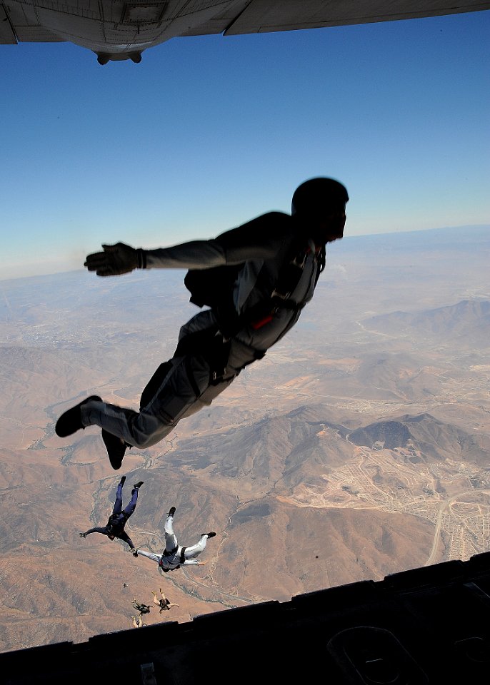 US Navy 080722-N-5366K-347 Freefall parachute jumpers leap from a C-130 at 12,500 feet over San Diego as part of their regular training cycle