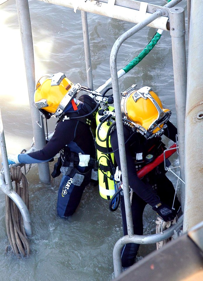 US Navy 080722-N-3446M-032 Senior Chief Navy Diver Paul Adams, assigned to Mobile Diving and Salvage Unit (MDSU) 1, and Indonesian Master Sgt. Santosa Efendy, are lowered into the water from the Military Sealift Command rescue