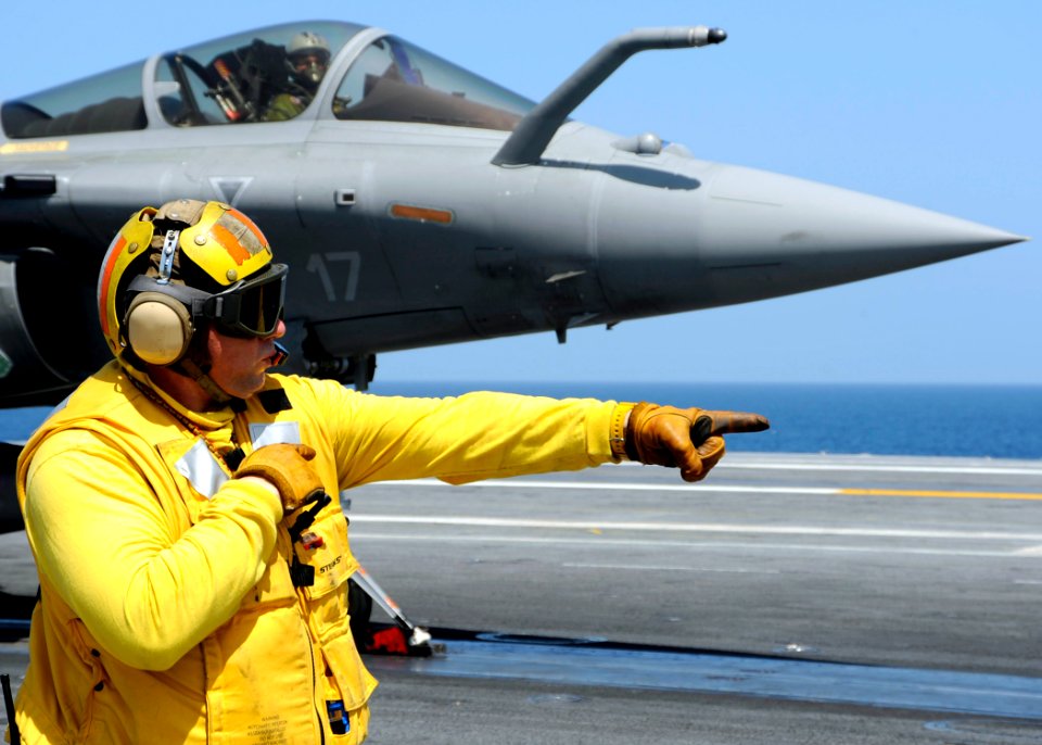 US Navy 080720-N-7571S-010 Chief Warrant Officer 3 Patrick Halinski gives control to a shooter launching a French F-2 Rafale during combined French and American carrier qualifications aboard the aircraft carrier USS Theodore Ro