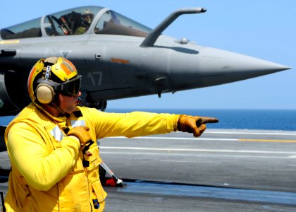 US Navy 080720-N-7571S-010 Chief Warrant Officer 3 Patrick Halinski gives control to a shooter launching a French F-2 Rafale during combined French and American carrier qualifications aboard the aircraft carrier USS Theodore Ro