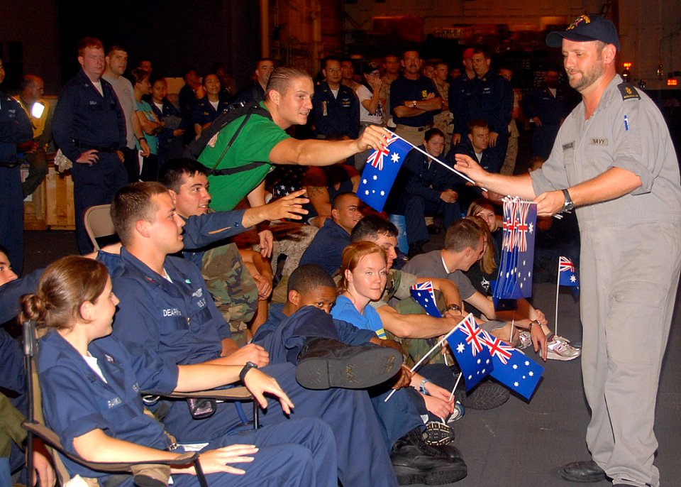 US Navy 080720-N-6999H-050 A member of the Royal Australian Navy Band passes out Australian flags to Sailors, Marines and embarked personnel