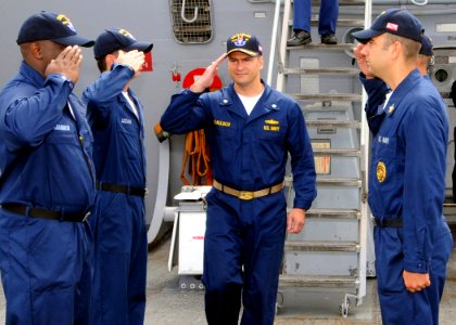 US Navy 080724-N-1082Z-006 Cmdr. Peter G. Galluch salutes as he passes through side boys during his arrival for the change of command