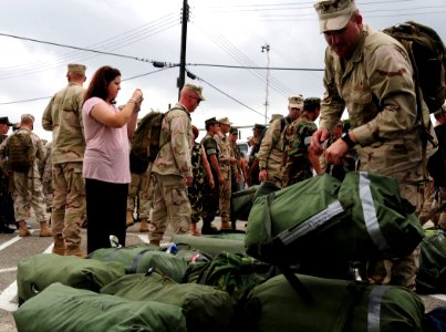 US Navy 080724-N-1688B-065 Equipment Operator 2nd Class Jason Sparrgrove, assigned to Amphibious Construction Battalion (ACB) 2, searches for his sea bag