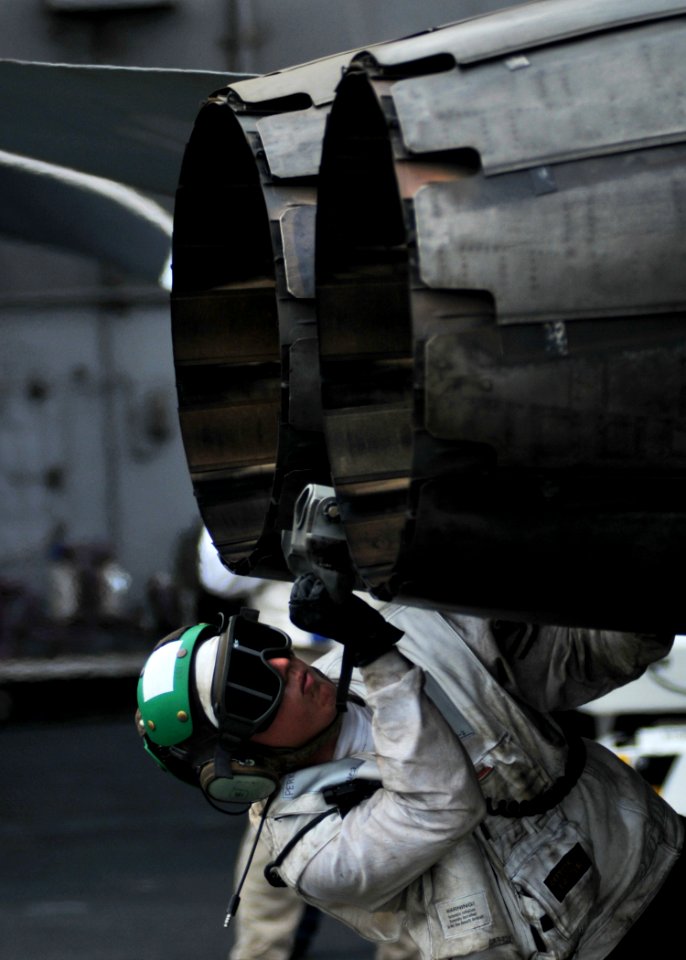 US Navy 080718-N-7981E-588 Aviation Structural Mechanic (Equipment) 2nd Class Donald Perkins checks the tail hook of an F-A-18C Hornet aboard the Nimitz-class aircraft carrier USS Abraham Lincoln (CVN 72)