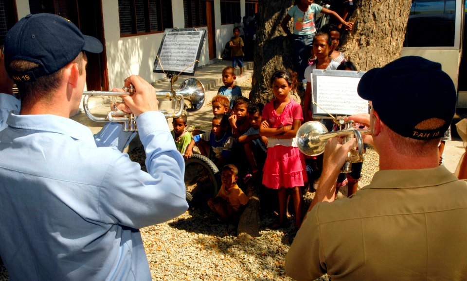 US Navy 080724-N-5911S-094 Members of the U.S. Navy Pacific Fleet Band, embarked aboard the Military Sealift Command hospital ship USNS Mercy (T-AH 19) perform for Timorese children during a ribbon-cutting ceremony during a Pac