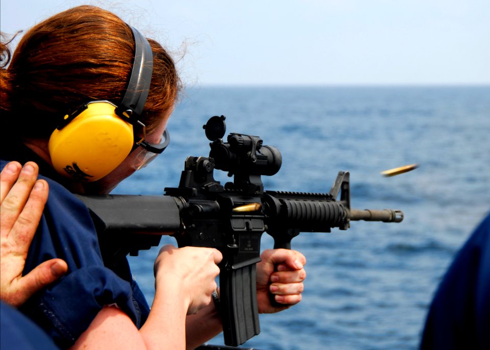 US Navy 080725-N-4236E-391 Fire Controlman Seaman Rachel Hubley fires an M4 carbine from the fantail of the guided-missile cruiser USS Vella Gulf (CG 72)