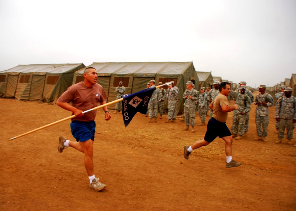 US Navy 080719-N-4973M-320 Construction Electrician 1st Class Samuel Roman carries the guide-on flag