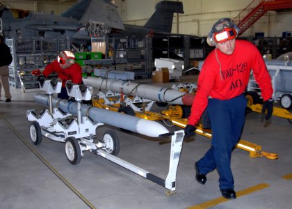 US Navy 080725-N-9860Y-003 Aviation Ordnancemen from Electronic Attack Squadron (VAQ) 129 move an advanced medium-range air-to-air missile (AMRAAM) into position for loading onto an EA-18G Growler