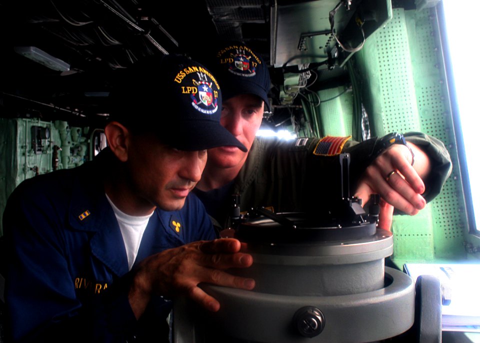 US Navy 080720-N-6764G-290 Chief Warrant Officer 2 John Rivera and Lt. Terry Menteer check bearings aboard the amphibious transport dock ship USS San Antonio (LPD 17)
