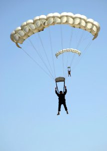 US Navy 080723-N-5366K-910 Parachute Rigger 2nd Class Andrew Tetoff flares the canopy of his MT-2XX parachute photo
