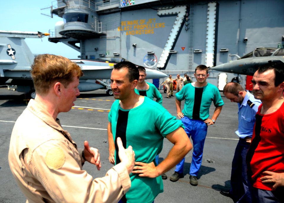 US Navy 080722-N-7241L-007 Capt. Dan Dixon speaks with First Master Patrice Lavolee of the French Navy