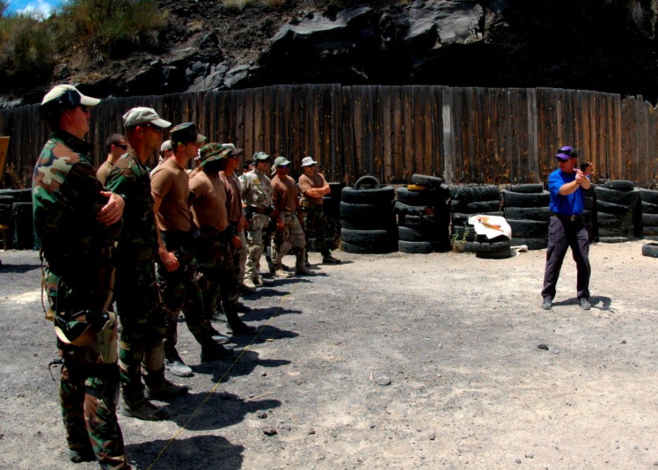 US Navy 080724-N-0577G-059 Wes Doss, an adjunct instructor for the National Rifle Association, teaches Sailors assigned to Explosive Ordnance Disposal Mobile Unit (EODMU) 8 how to handle a pistol with just one hand