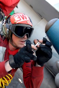 US Navy 080723-N-7730P-133 Aviation Ordnanceman 2nd Class David Mathews installs a set screw after replacing a nose plug on a laser guided bomb unit (GBU) 32 bomb aboard the Nimitz-class nuclear-powered aircraft carrier USS Ron