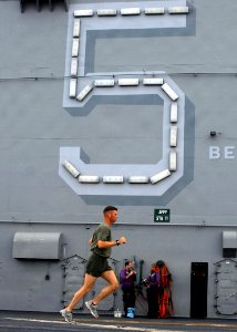 US Navy 080724-N-5148B-001 A Marine takes advantage of a break in flight operations for a workout on the flight deck of the amphibious assault ship USS Peleliu (LHA 5)