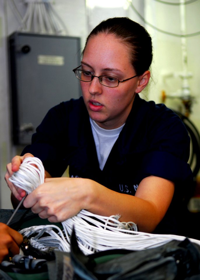 US Navy 080729-N-2638R-004 Aircrew Survival Equipmentman Airman Jessica Lockhart packs an A-P22P-11 parachute in the parachute loft aboard the aircraft carrier USS Kitty Hawk (CV 63)