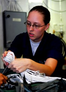 US Navy 080729-N-2638R-004 Aircrew Survival Equipmentman Airman Jessica Lockhart packs an A-P22P-11 parachute in the parachute loft aboard the aircraft carrier USS Kitty Hawk (CV 63)