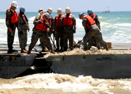 US Navy 080724-N-1424C-314 olidiers flex the Army Trident pier at Gold Beach during Joint Logistics Over-The-Shore (JLOTS) 2008