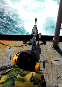 US Navy 080725-N-4236E-006 Gunner's Mate 2nd Class Dian Jiang shoots an M240B machine gun off the fantail of the guided-missile cruiser USS Vella Gulf (CG 72). Vella Gulf is participating in Joint Task Force Exercise (JTFEX) 08