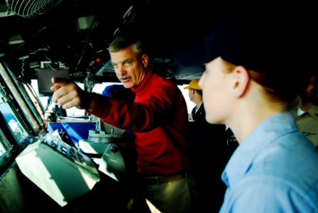 US Navy 080722-N-3946H-039 Capt. Todd Zecchin, commanding officer of the aircraft carrier USS Kitty Hawk (CV 63), explains aircraft recovery to Hospital Corpsman 3rd Class Cassandra Wildey, of Grand Rapids, Mich., on the ship's
