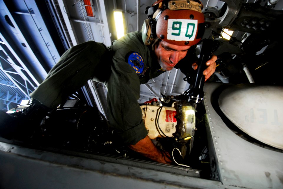 US Navy 080725-N-3946H-063 Aviation Warfare Systems Operator 1st Class Ryan Branco inspects the hydraulics system of an SH-60F Seahawk