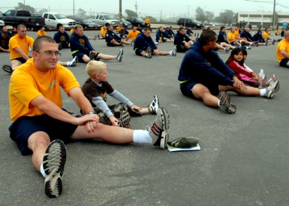 US Navy 080725-N-8547M-015 Construction Mechanic 1st Class Gail R. Best and Equipment Operator 1st Class Perry Taitano, both assigned to Naval Mobile Construction Battalion (NMCB) 5, participate in physical training (PT) with t photo