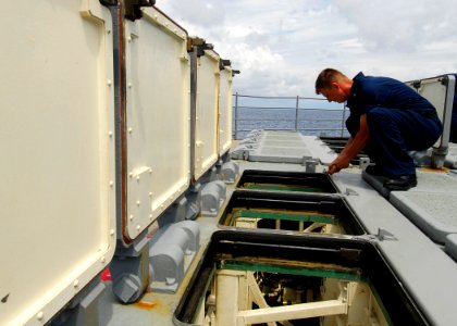 US Navy 080724-N-4236E-120 Gunner's Mate 1st Class Robert Lambert performs maintenance on the missile deck