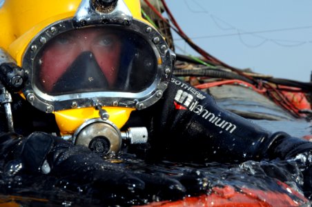 US Navy 080726-N-8298P-117 Navy Diver 1st Class Jason Potts swims on to the stern of the former Soviet submarine Juliett 484 to conduct salvage operations photo