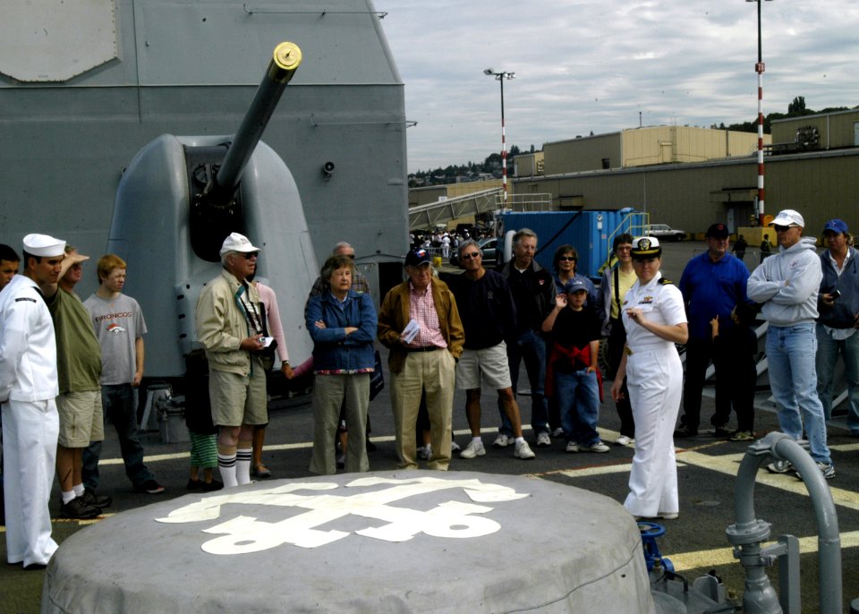 US Navy 080731-N-4649C-003 Ensign Samantha Foxton describes the ship's anchor assembly to a tour group on the ship's foc'scle