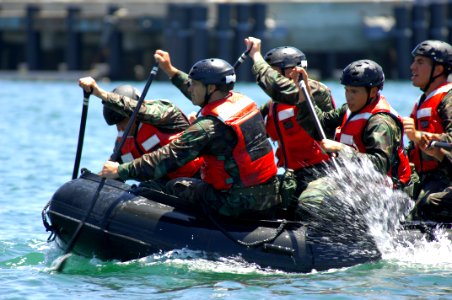 US Navy 080723-N-2959L-442 Basic crewman training (BCT ) students paddle a combat rubber raiding craft (CRRC) through San Diego Bay during their first underway in a CRRC at Naval Amphibious Base Coronado photo