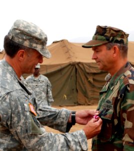 US Navy 080801-N-4973M-052 Brig. Gen. Mark MacCorley, deputy commander of Joint Task Force (JTF) 8, awards the Meritorious Service Medal to Capt. Thomas Weatherald, commander of Joint Logistics Over-The-Shore (JLOTS) 2008