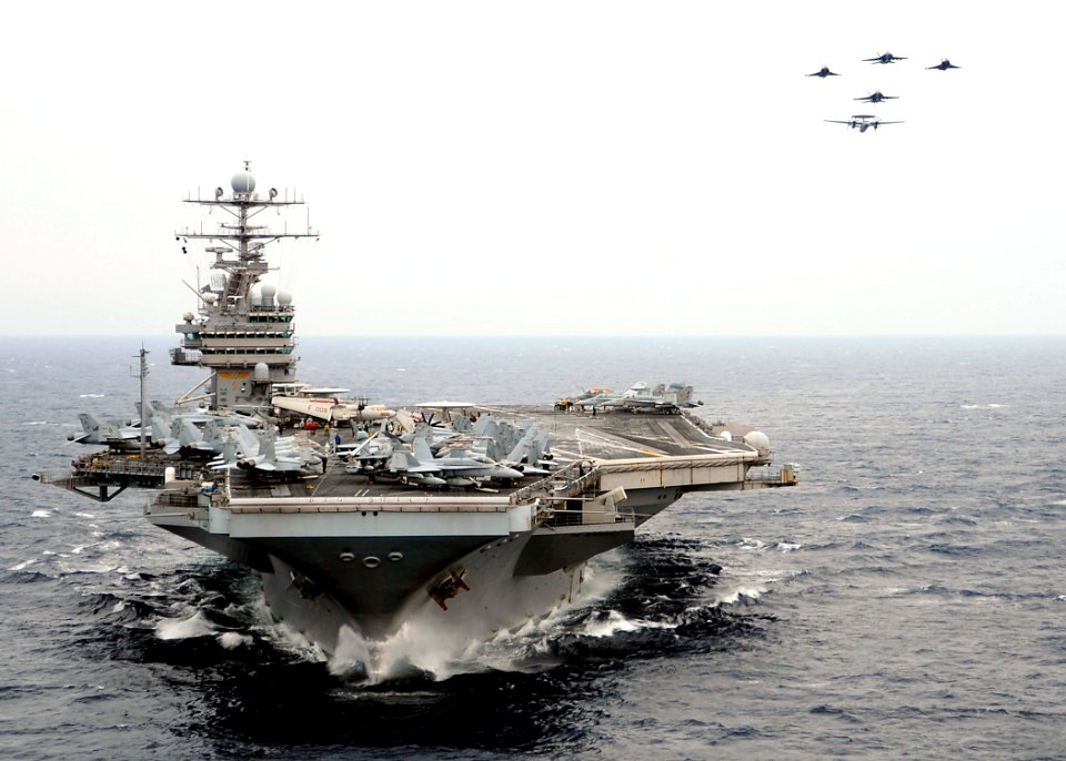 US Navy 080723-N-7571S-002 French F-2 Rafale M, E-2C Hawkeye and American F-A-18 Super Hornet aircraft perform a fly-by over the aircraft carrier USS Theodore Roosevelt (CVN 71)