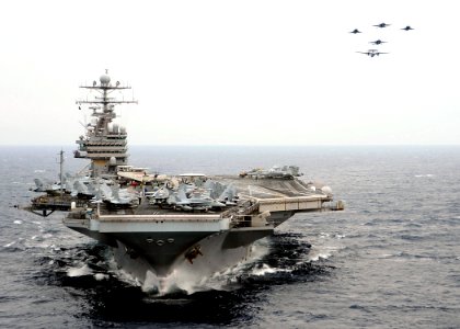 US Navy 080723-N-7571S-002 French F-2 Rafale M, E-2C Hawkeye and American F-A-18 Super Hornet aircraft perform a fly-by over the aircraft carrier USS Theodore Roosevelt (CVN 71)