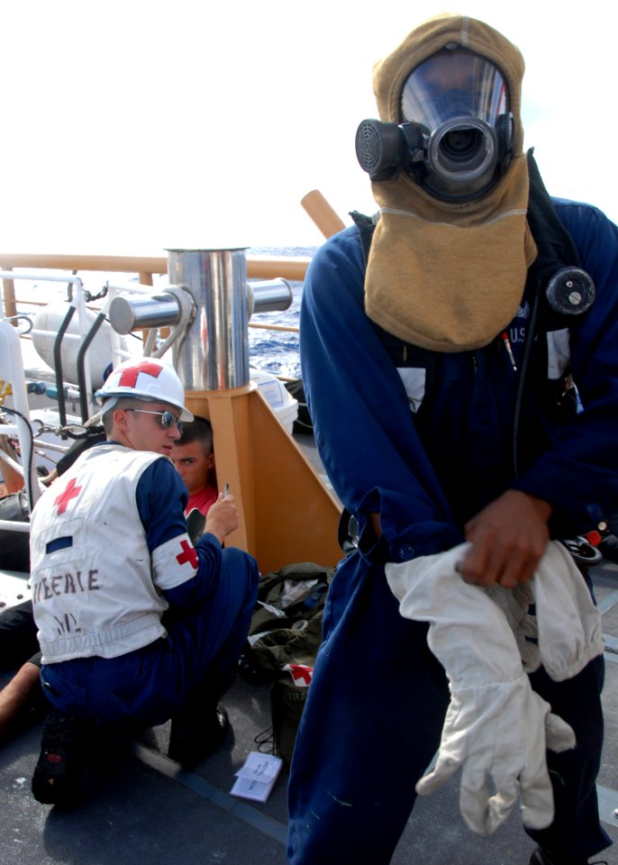 US Navy 080805-N-9758L-076 amage Controlman 2nd Class Tavarish McNair dons firefighting gear