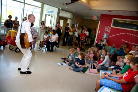 US Navy 080804-N-3271W-002 American Idol finalist Mass Communication Specialist 3rd Class Phil Stacey sings to patients and staff photo