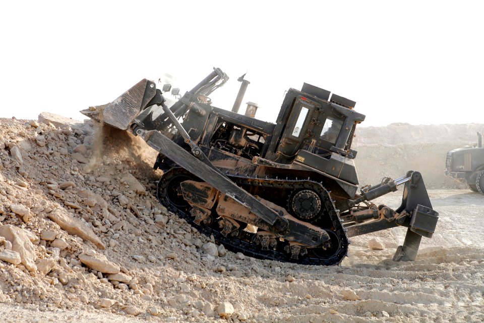 US Navy 080728-N-9623R-009 Equipment Operator 2nd Class Omar Shariff White moves dirt that will be used in the hescos at an Al Qaim