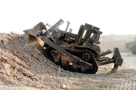 US Navy 080728-N-9623R-009 Equipment Operator 2nd Class Omar Shariff White moves dirt that will be used in the hescos at an Al Qaim